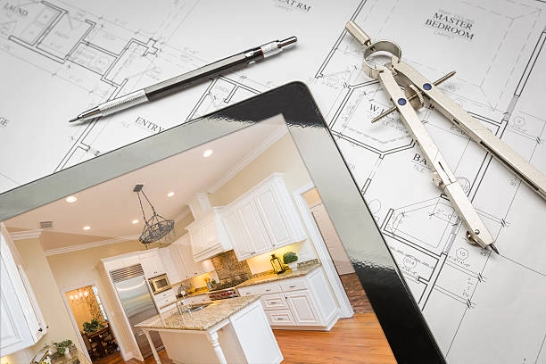 tablet on table with compass tool, pen and house blueprint -contractor home improvement