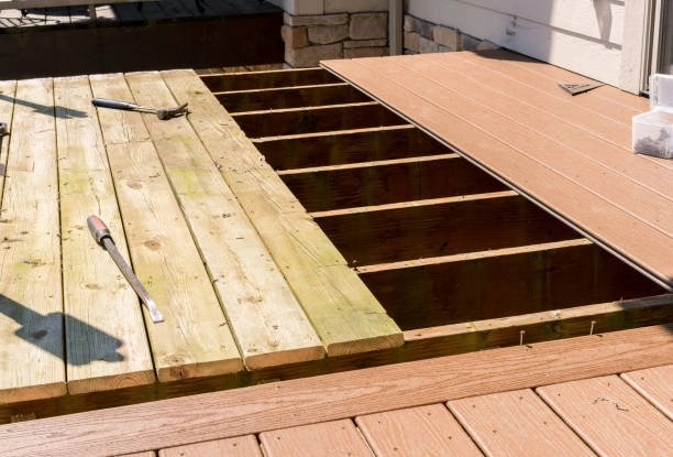 Deck renovation in progress, replacing old wooden boards with new composite decking. -constructed decks