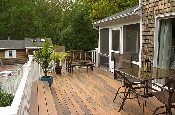 Cozy wooden deck with outdoor seating, plants, and scenic surroundings. -composite decking