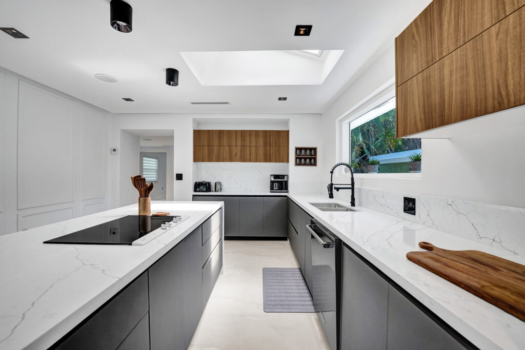 white and dark wood kitchen with euro design and whitequartz countertops
